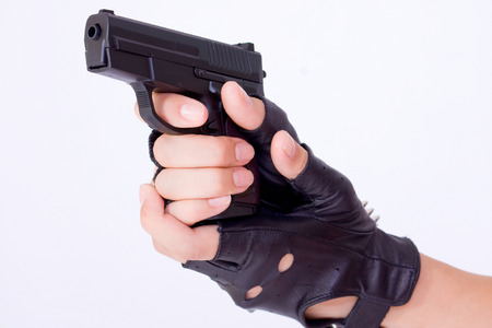 close up of female hand holding a gunの写真素材