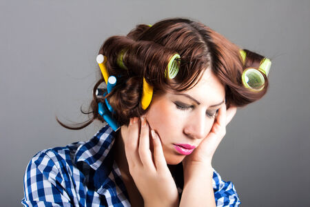 portrait of sexy housewife with curlers  pin up portraitの写真素材