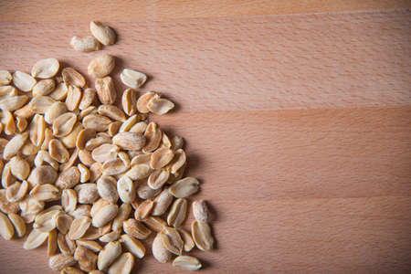 Peanuts on wooden background. The concept of healthy eating.