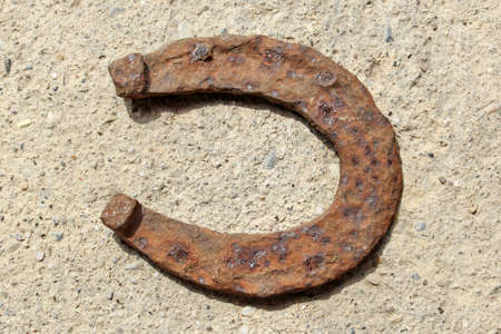 Rusty horseshoe over concreteの写真素材