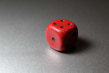 Old deserved red dice, taken on the silver metal surfaceの写真素材