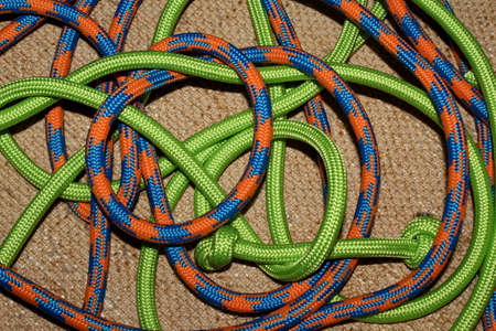 Colorful wrapped ropes, green, blue and orange ropes photographed with brown background