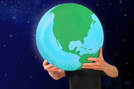 man holds in his strong hands the globe on a blue cosmic background, the concept of globalization, environmental protection, ecologyの写真素材