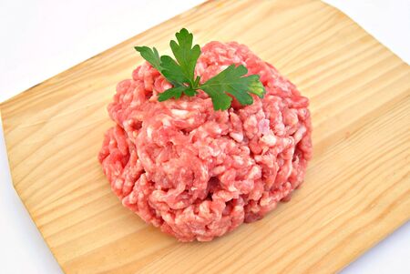 Minced meat on wooden boardの写真素材