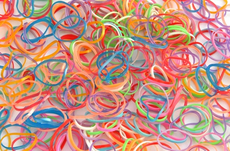 Rubber bands of different colors stacked next to each other forming a fund