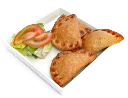 Several pies next to each other with salad served on a plateの写真素材