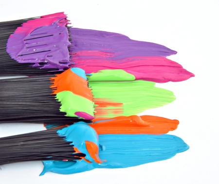 Paint of different colors with three brushesの写真素材