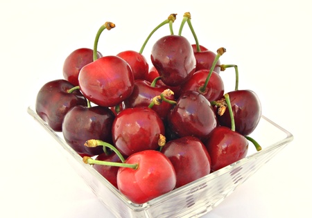 Cherries stacked next to each other on a glass jarの写真素材