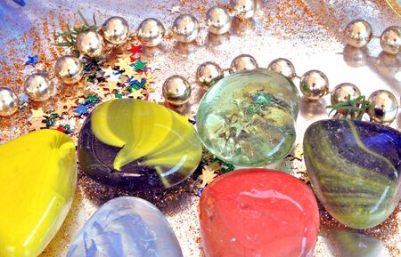 Brightly colored stones on silver background