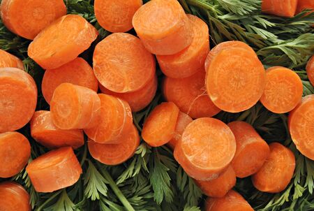 Fund sliced carrots on a green background