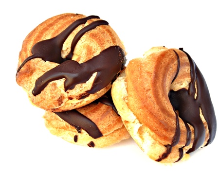Several chocolate donuts and cream, surrounded by white