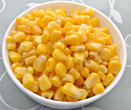 Bowl of corn kernels on a tablecloth blue tones