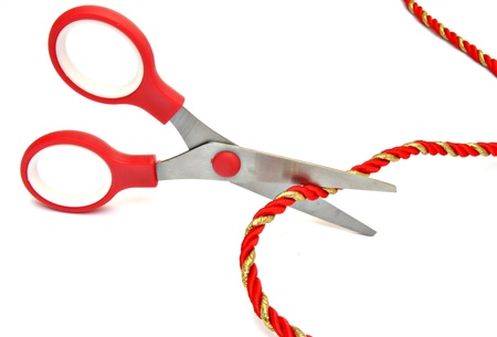 Scissors cutting a cord, surrounded by white backgroundの写真素材