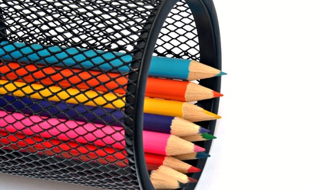Pencils of various colors next to each other, within a penの写真素材