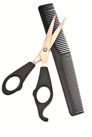 Scissors for cutting hair on a comb, surrounded by white backgroundの写真素材