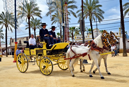 People in carriage horses walking in the royal house of the fair on the horse fair the day May 12, 2012 in Jerez de la Frontera, Spain のeditorial素材