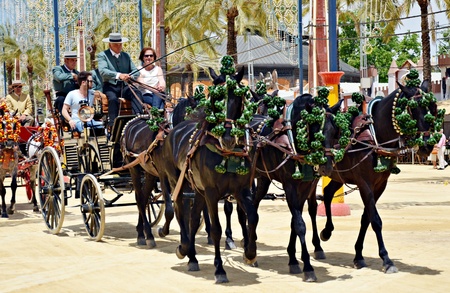People in carriage horses walking in the royal house of the fair on the horse fair the day May 12, 2012 in Jerez de la Frontera, Spain のeditorial素材