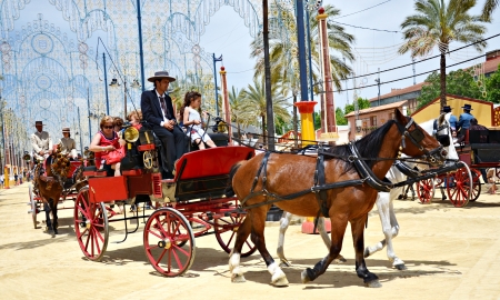 People in carriage horses walking in the royal house of the fair on the horse fair the day May 12, 2012 in Jerez de la Frontera, Spain のeditorial素材