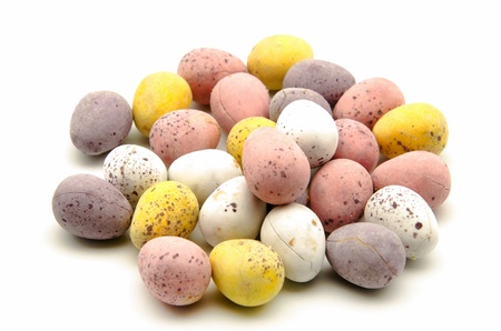Eggs filled with chocolate candy surrounded by white background
