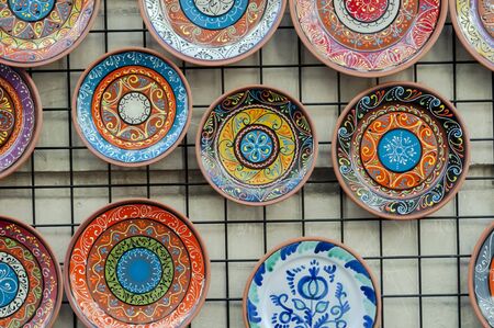 Several ceramic plates placed next to each other decorated with various details