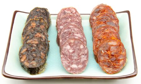 Pudding, sausage and Iberian Spanish salami on white bottom