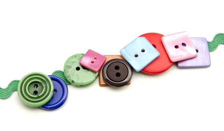 Plastic buttons in different colors on white fund 