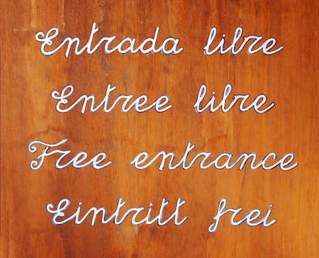 Abstract background in wooden that makes the text with letters, free entrance, written in several languageの写真素材