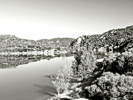 River surrounded by mountains reflected of the Sierra of Cadiz , is located in the Spanish province of Cadiz, it´s a black and white imagenの写真素材