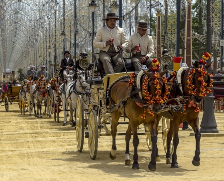 JEREZ DE LA FRONTERA, SPAIN-MAY 10: People in carriage horses walking in the royal house of the fair on the horse fair the day May 10, 2013 in Jerez de la Fronteraのeditorial素材