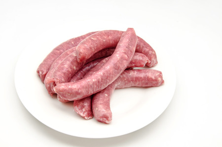 Several fresh meat sausages on white backgroundの写真素材