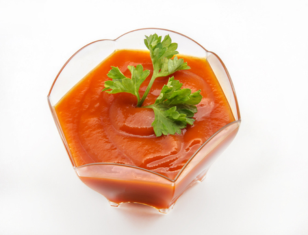 Tomato sauce served in a bowl on white backgroundの写真素材