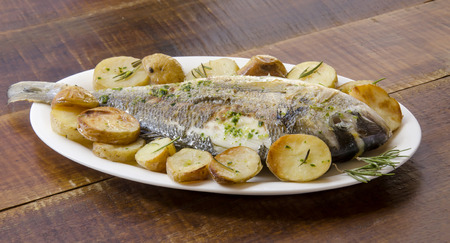 Baked fish with roasted potatoesの写真素材