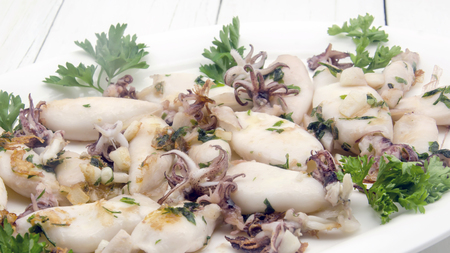 Grilled squid cooked with garlic and parsleyの写真素材
