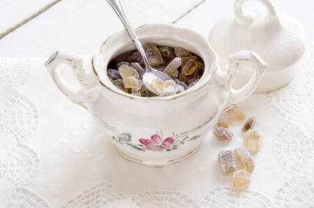 An old porcelain sugar bowl with brown sugarの写真素材