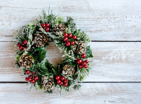 Decorated Christmas wreath on wooden backgroundの写真素材