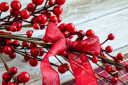 Christmas Red ribbon on holly leavesの写真素材