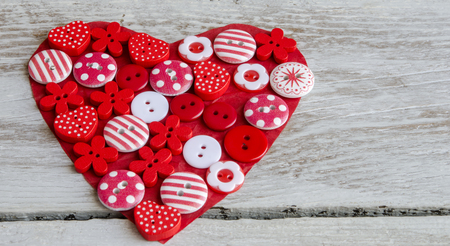 Red heart covered with colorful buttons.Valentine's day. From aboveの写真素材