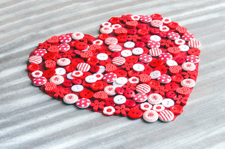 Red heart covered with colorful buttons.Valentine's day. From aboveの写真素材