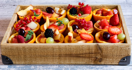 View of healthy and fresh tartes full of summer berries and fruitの写真素材