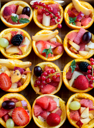 Close-up of delicious bright berries and fruit in orange tartesの写真素材
