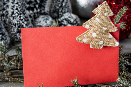 Sheet of red paper with beige textile Christmas toyの写真素材