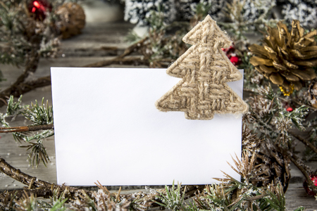 A sheet of paper laying in Christmas decor. Horizontal studio shotの写真素材