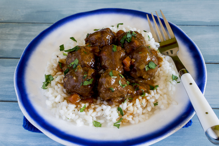 Meatballs with rice and vegetable and tomato sauceの写真素材