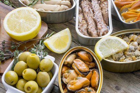 Assortment of cans of canned with different types of fish and seafoodの写真素材