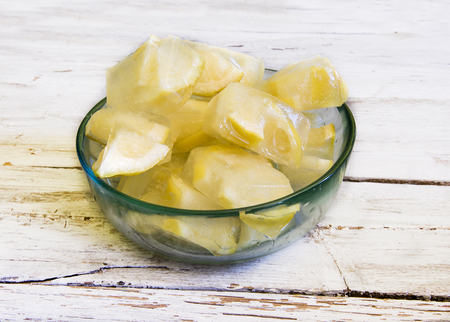 Ice cubes with frozen lemonsの写真素材