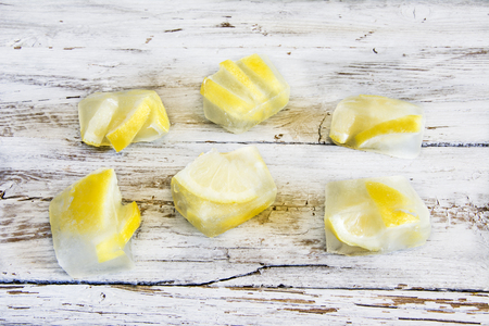 Ice cubes with frozen lemonsの写真素材