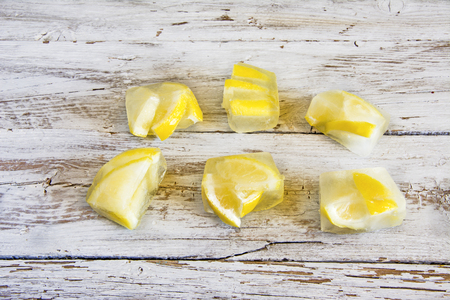 Ice cubes with frozen lemonsの写真素材