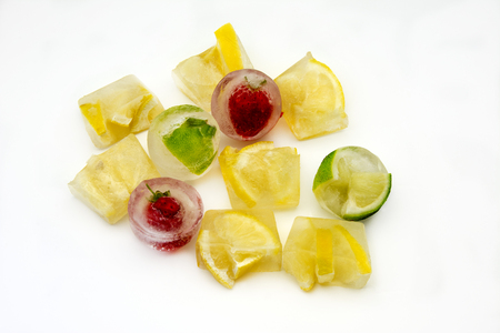 Ice cubes with lemons and frozen strawberriesの写真素材