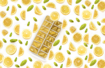 Ice cubes with lemons on white backgroundの写真素材