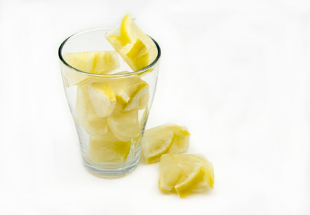 Ice cubes with frozen lemonsの写真素材